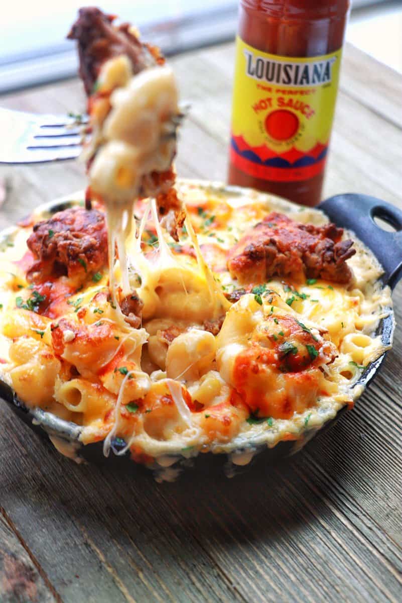 Fried Chicken Mac n Cheese being pulled out the skillet with a fork.