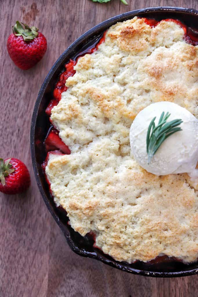 Skillet Strawberry Cobbler with a scoop of vanilla ice cream.