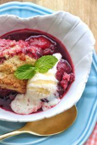Plum Cobbler in a bowl with ice cream