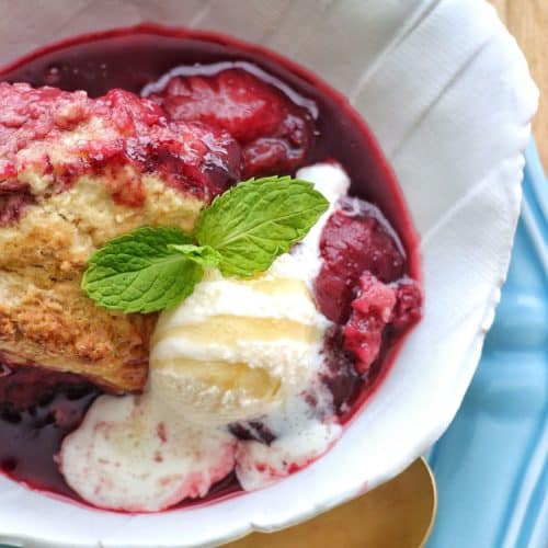 Plum Cobbler in a bowl with ice cream