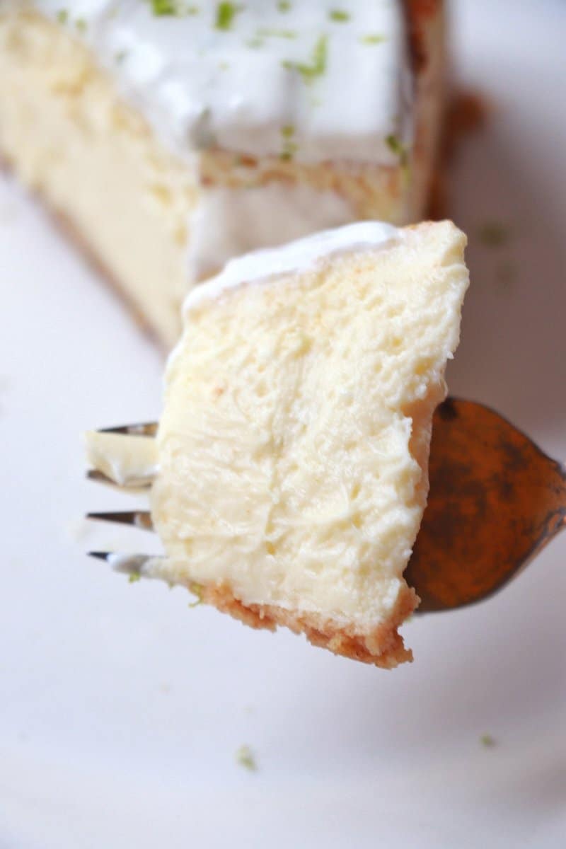 A piece of Key Lime Cheesecake on a fork.