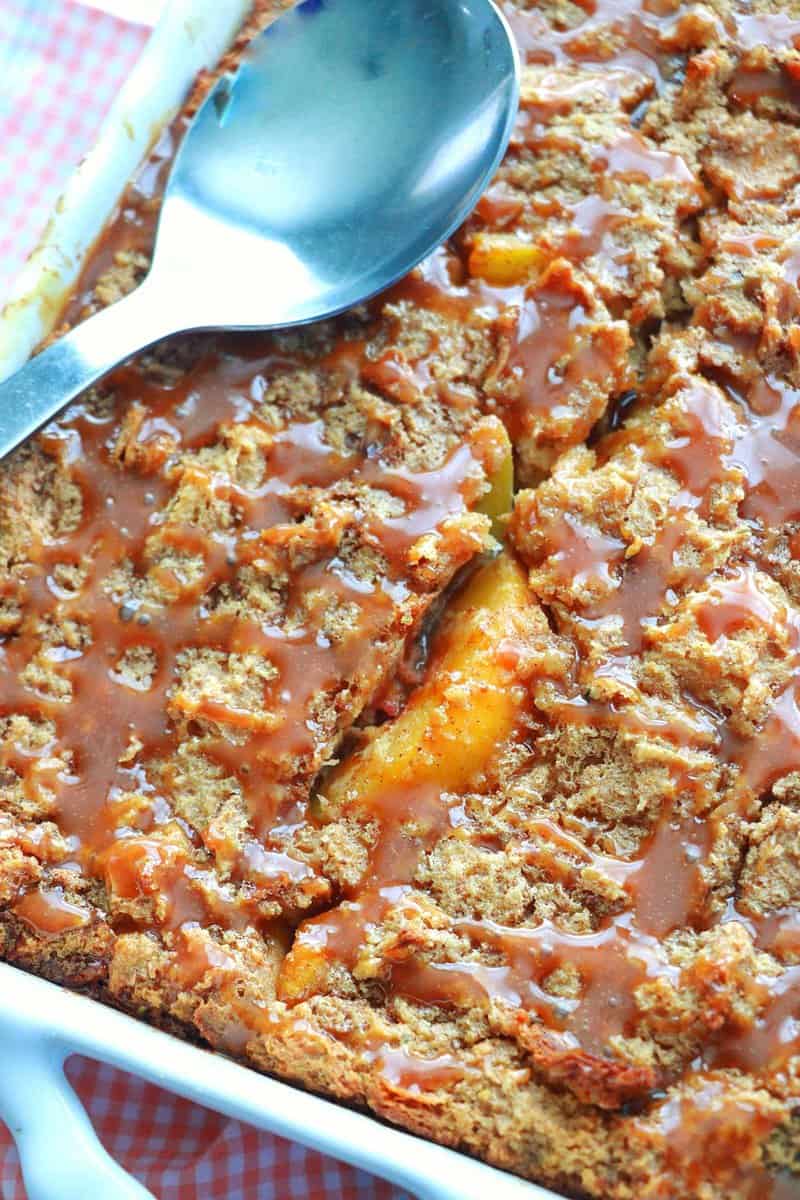 Peach Bread Pudding with Caramel Sauce in a baking pan.