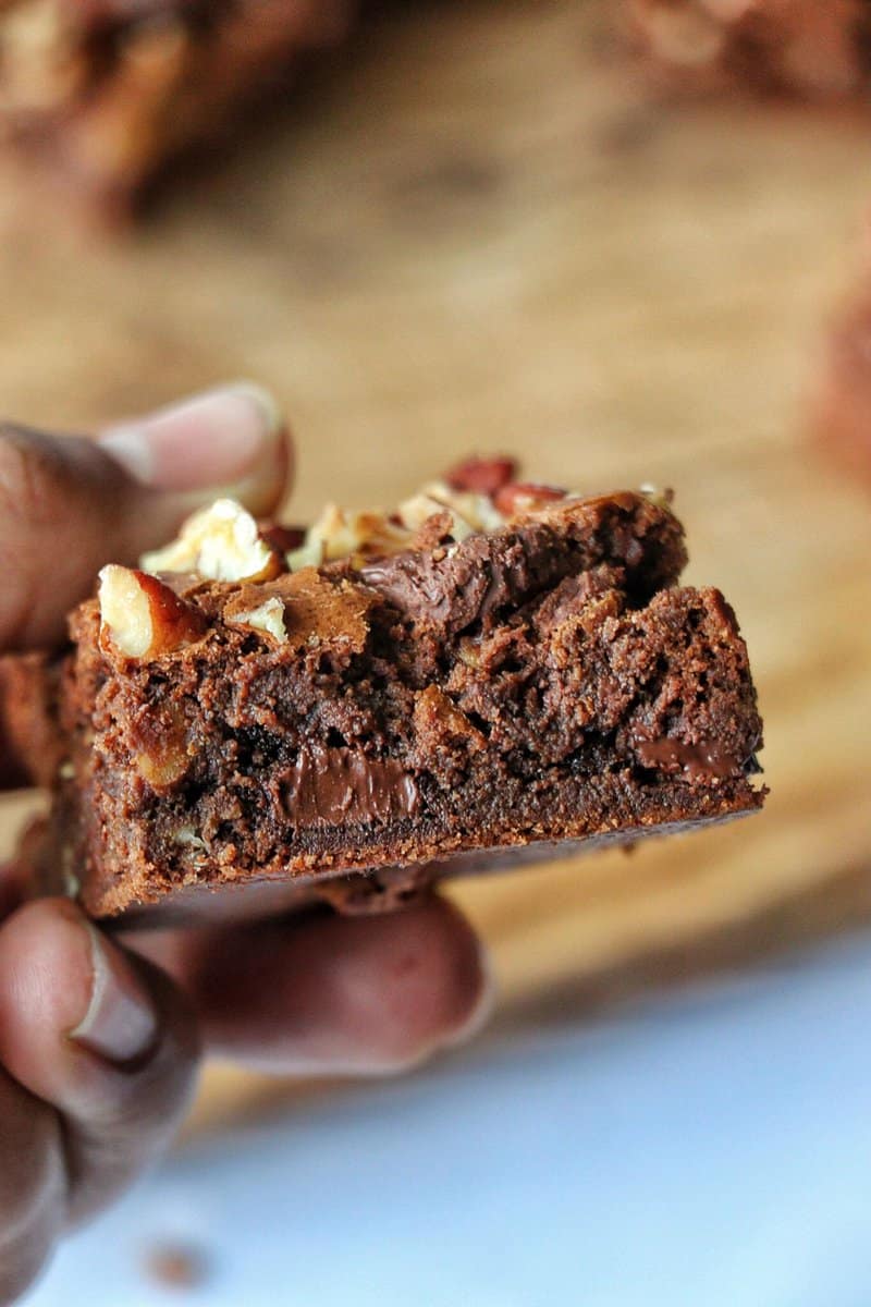 Triple chocolate brownies in a hand