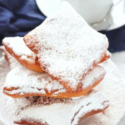 Classic Beignets on plate with cup of coffee