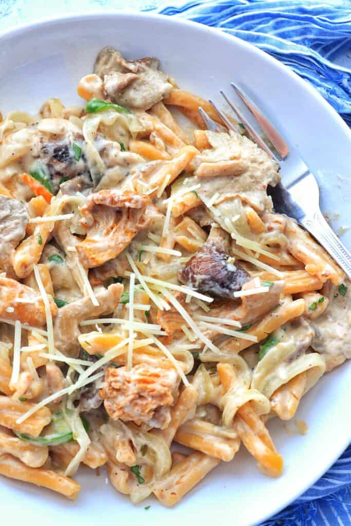 Cajun Mushroom Pasta on a plate with a fork.