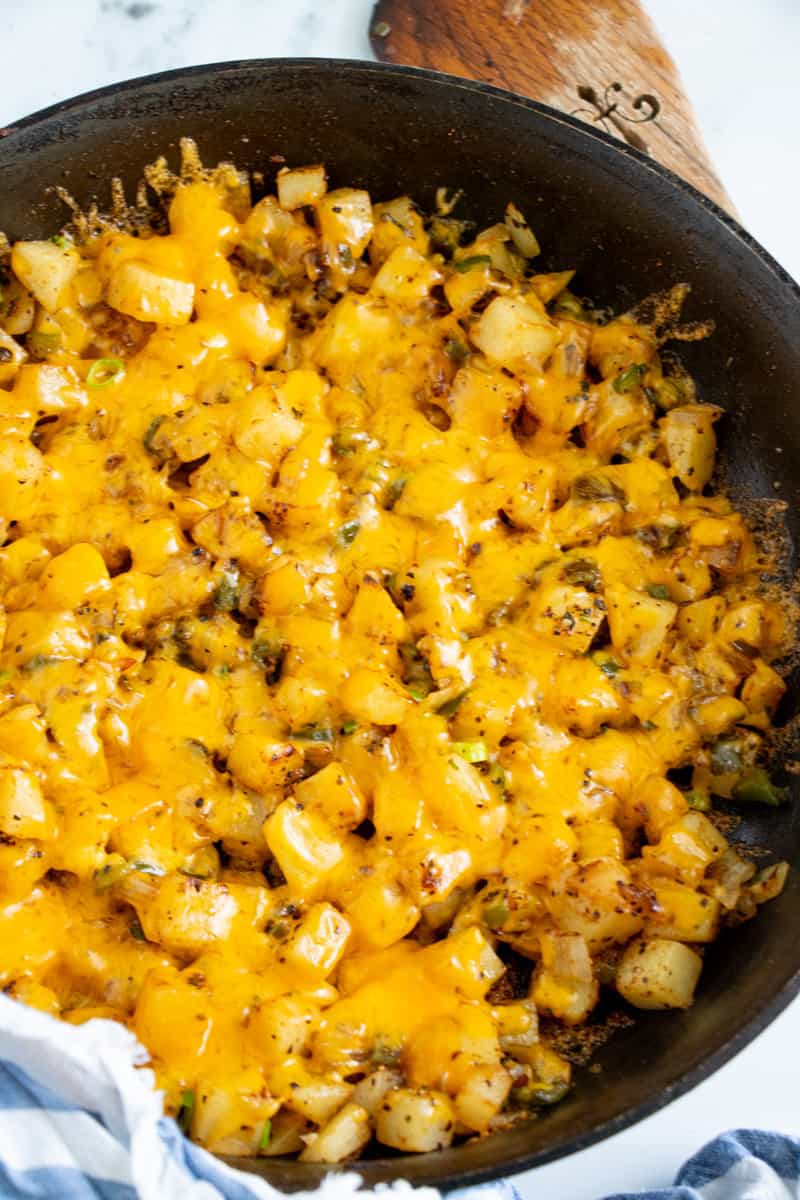 Breakfast potatoes with cheese in a skillet