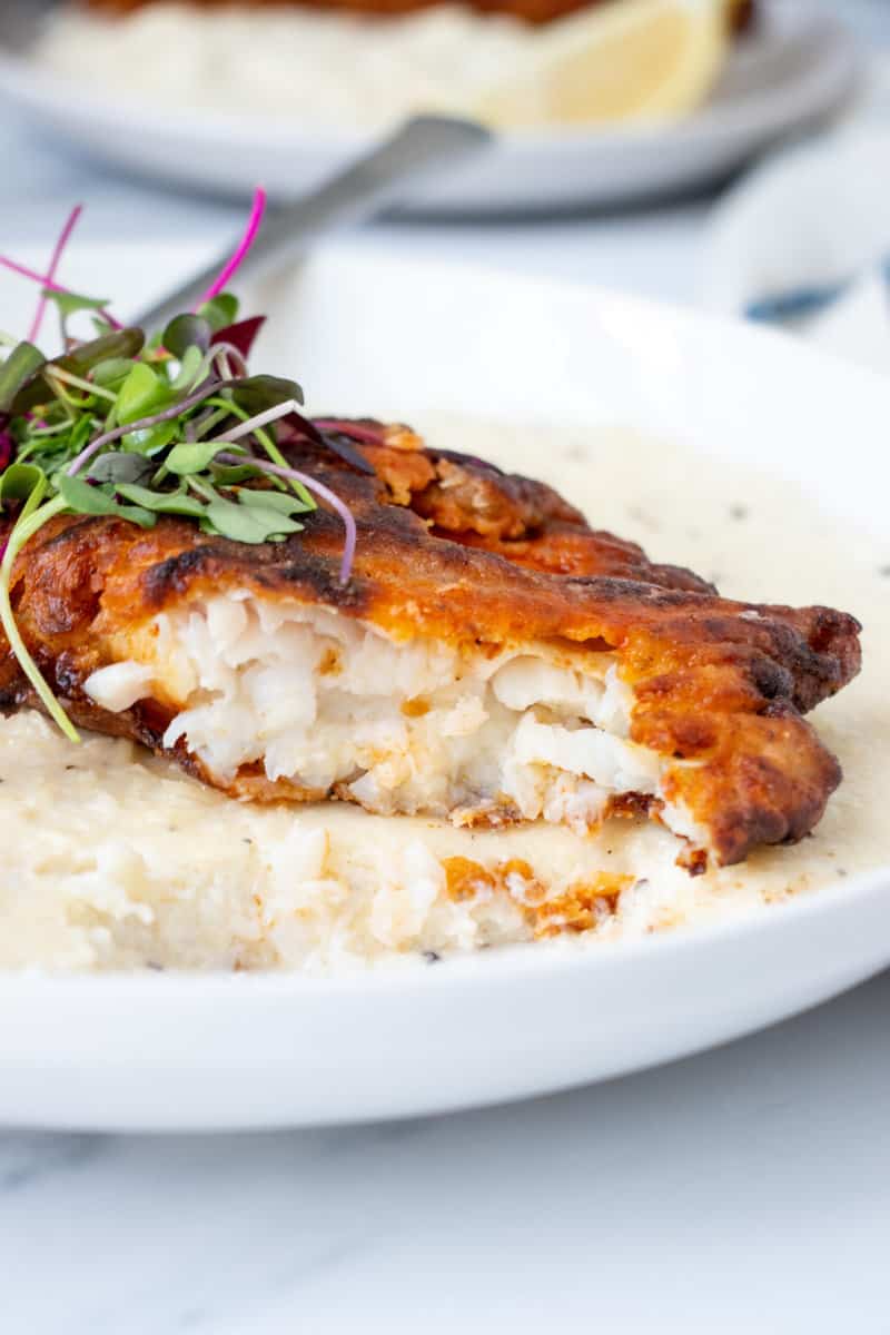Cajun Fish and Grits on a plate