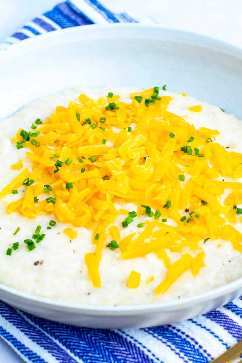 close shot of shot of cheddar cheese grits on a blue towel