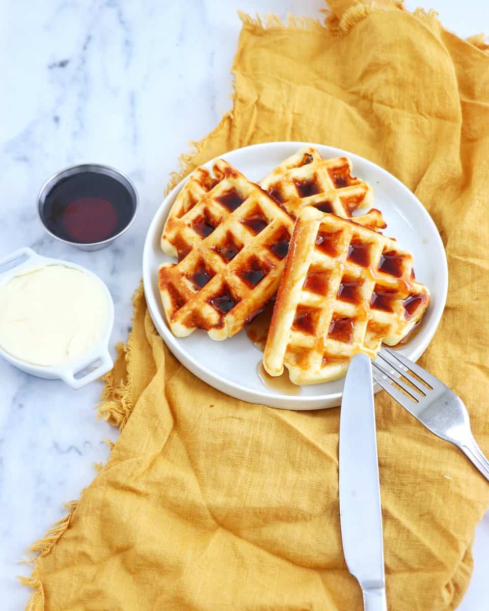 sweet corn waffles on a plate with a yellow towel