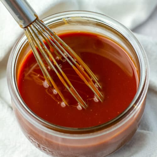 caramel sauce in glass jar with whisk