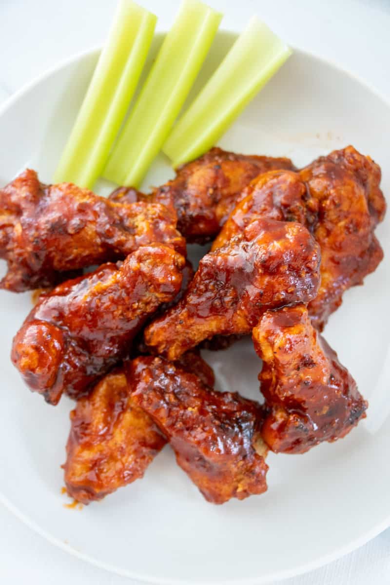 Honey BBQ Wings on a plate with celery