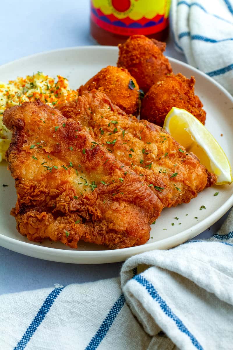 Southern Fried Fish on a plate with hush puppies