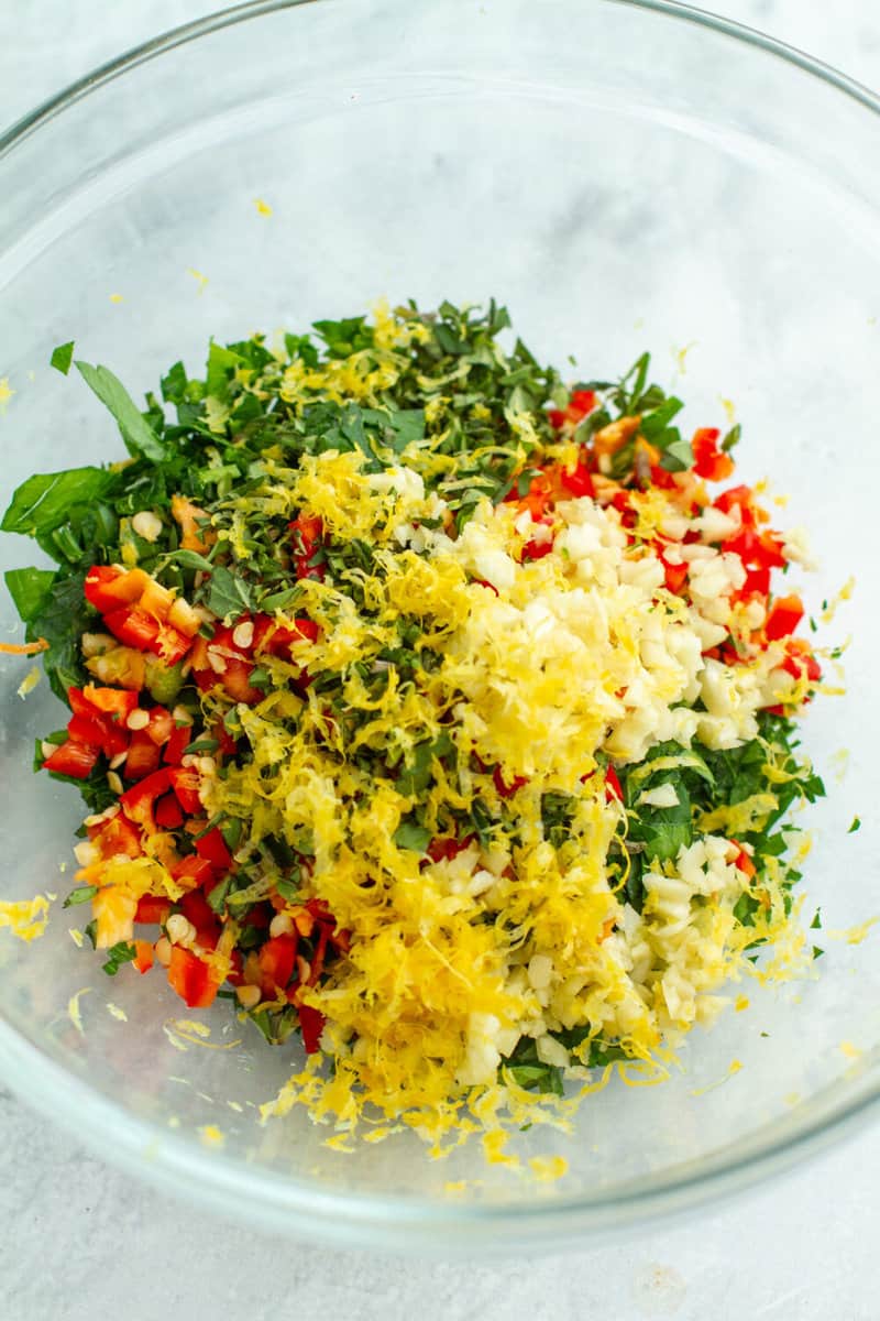 Chopped ingredients in a bowl for Chimichurri Sauce