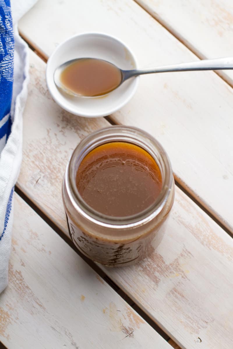 Bourbon Sauce in a mason jar with a spoon filled with sauce