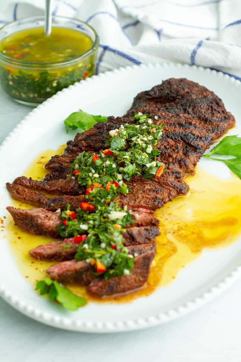 Grilled Skirt Steak with Chimichurri Sauce on a plate.