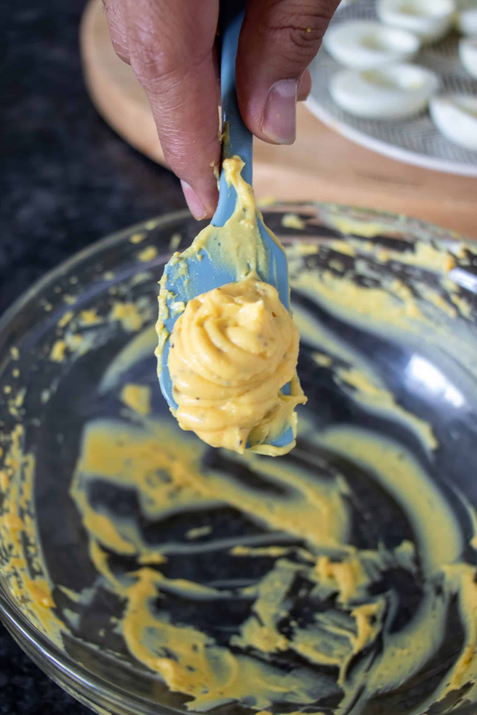 Creamy Cajun deviled egg filling on a spatula.