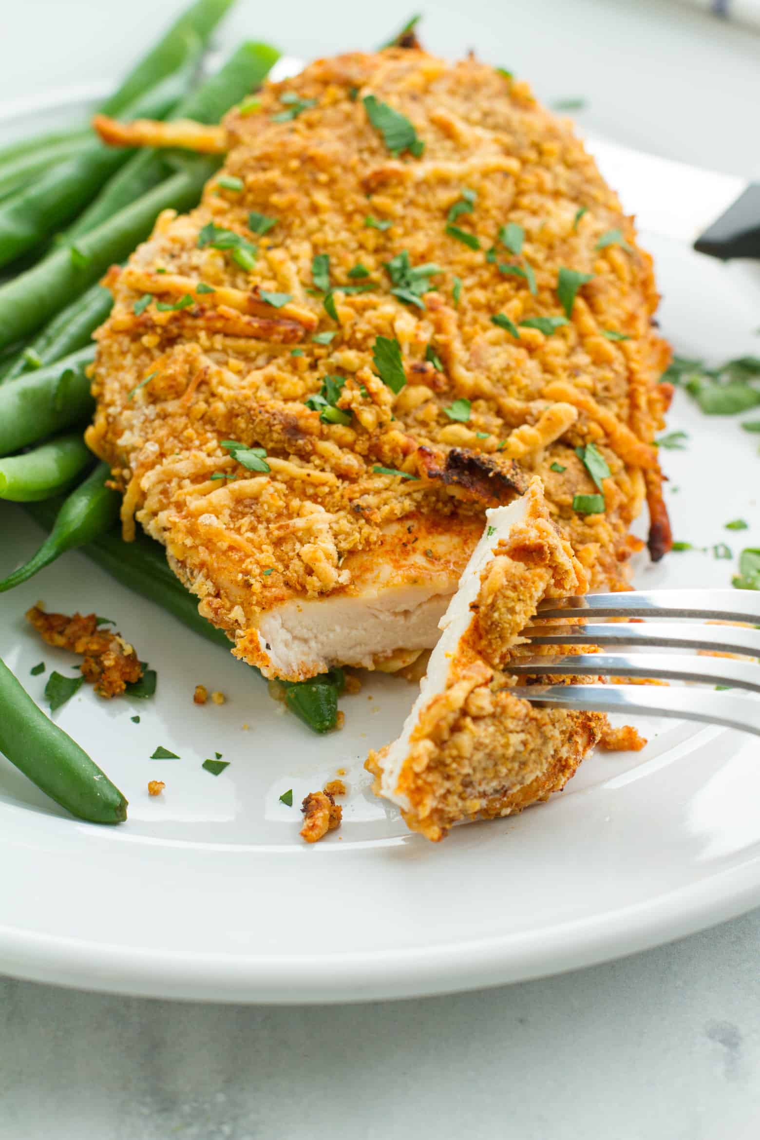 Parmesan Crusted Chicken (Air Fryer) sliced on a fork.