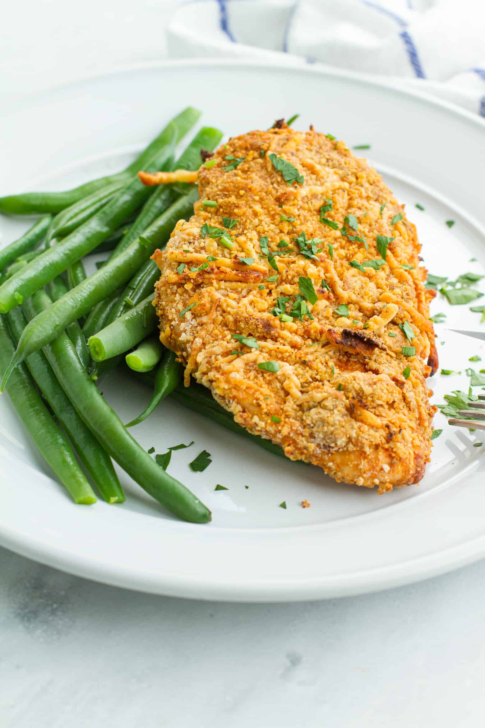 Parmesan Crusted Chicken (Air Fryer) with green beans on a plate.