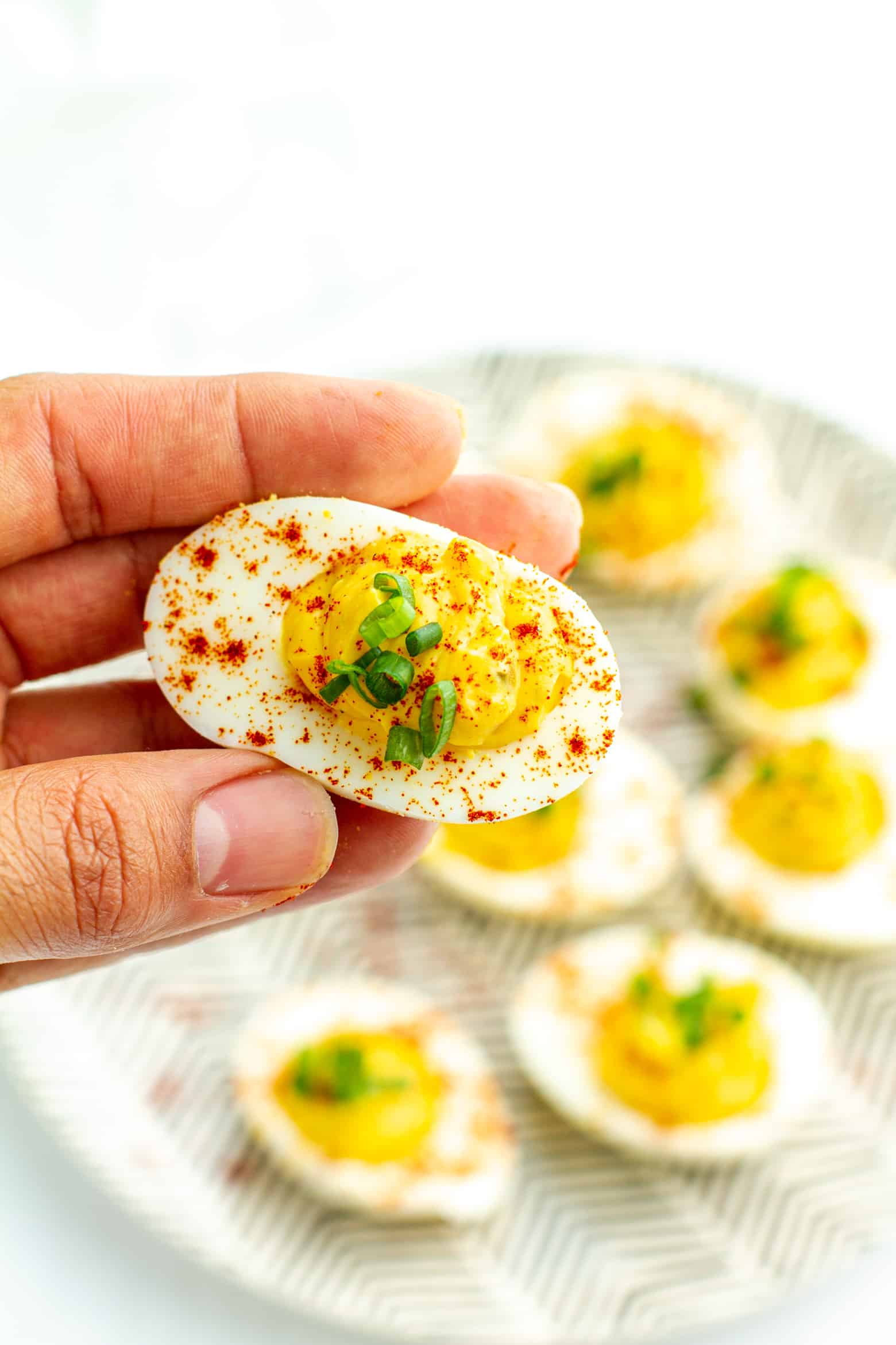 Southern Deviled Eggs being held in hand.