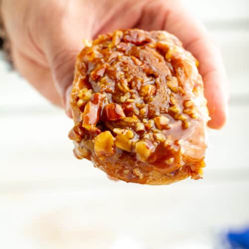 Sticky bun being held in hand.
