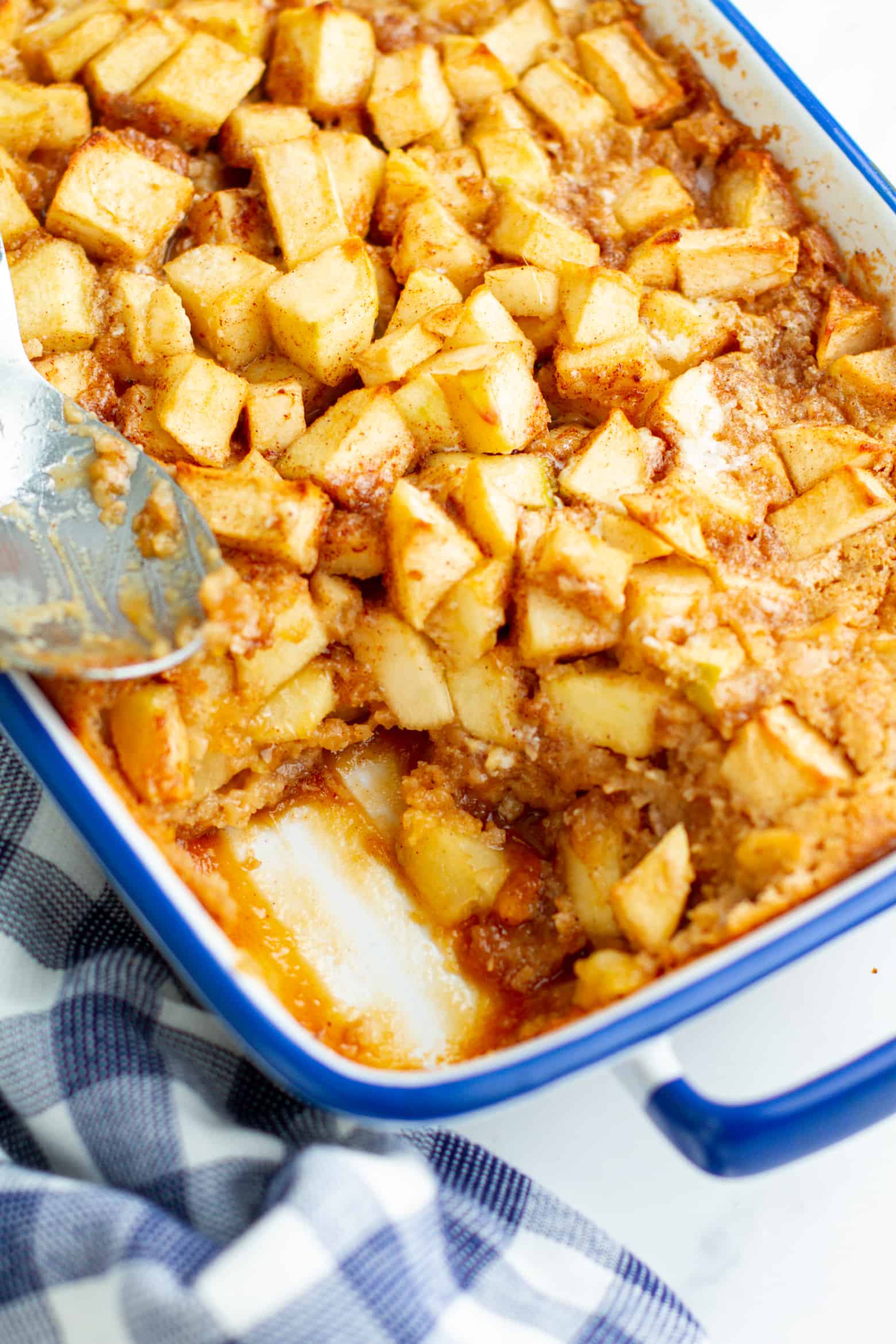 Easy Apple Cobbler in baking dish with a portion missing.