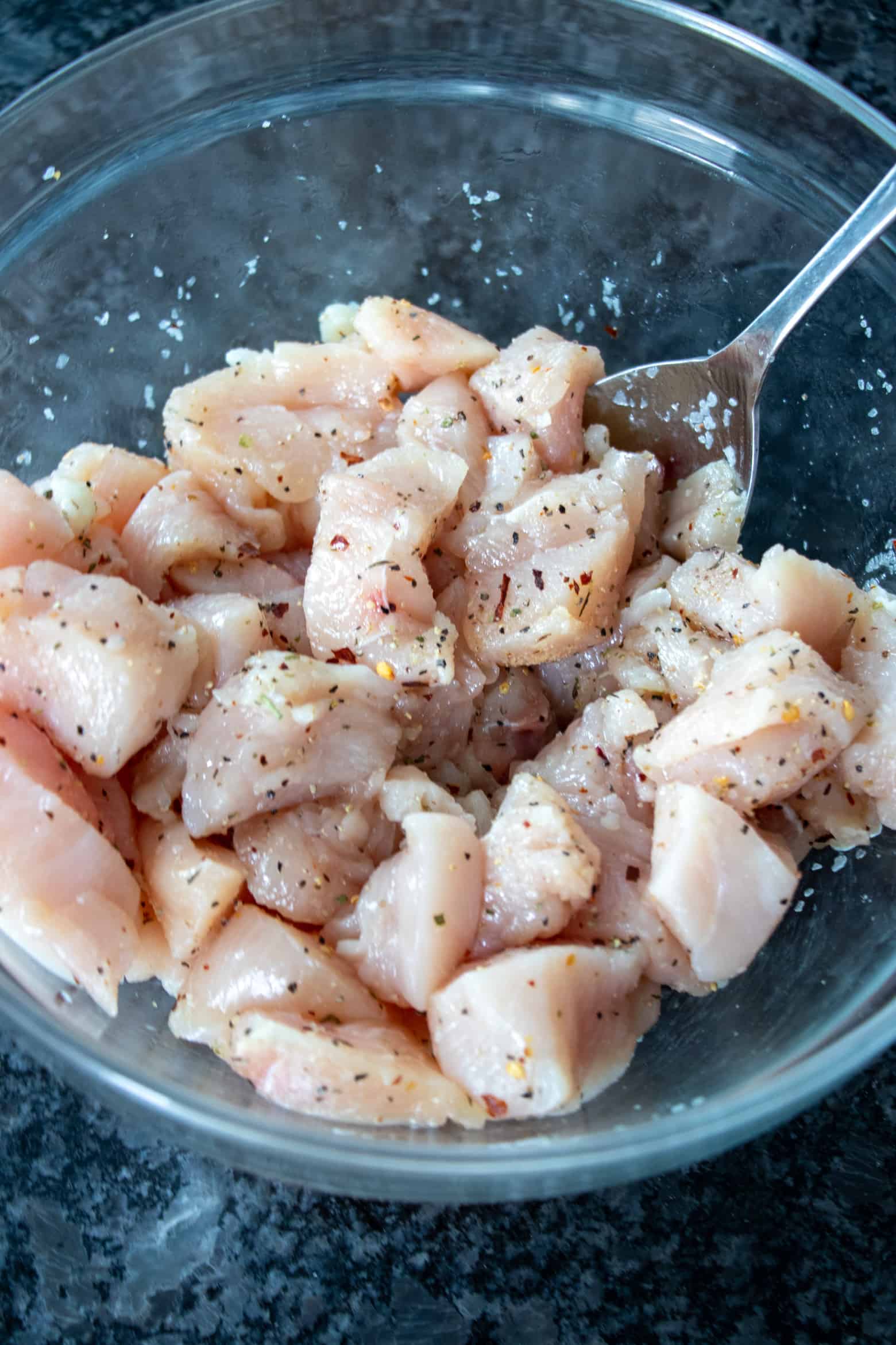 Seasoned chopped chicken breasts in a bowl