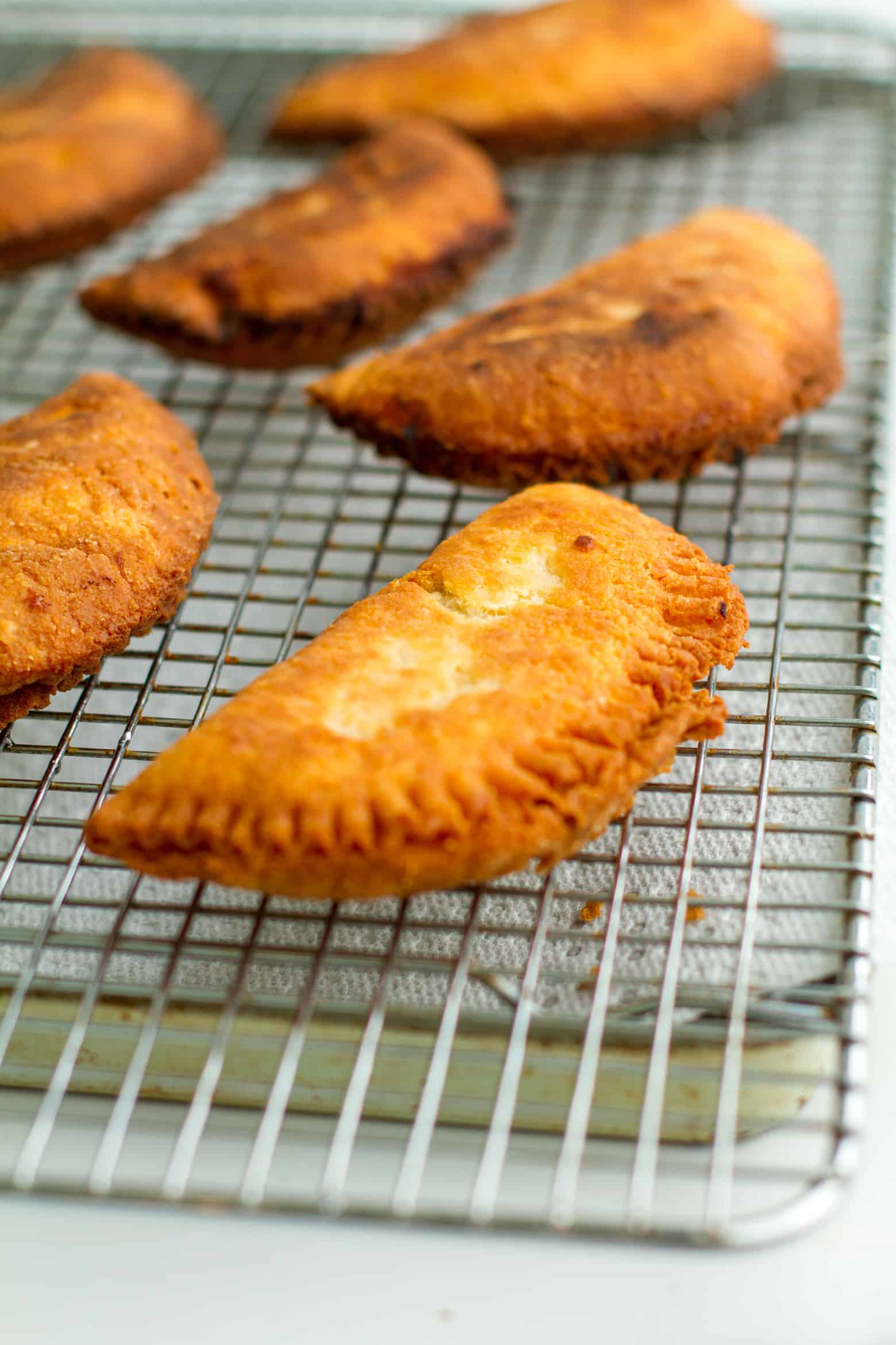 Fried pies cooling on a cooling rack.