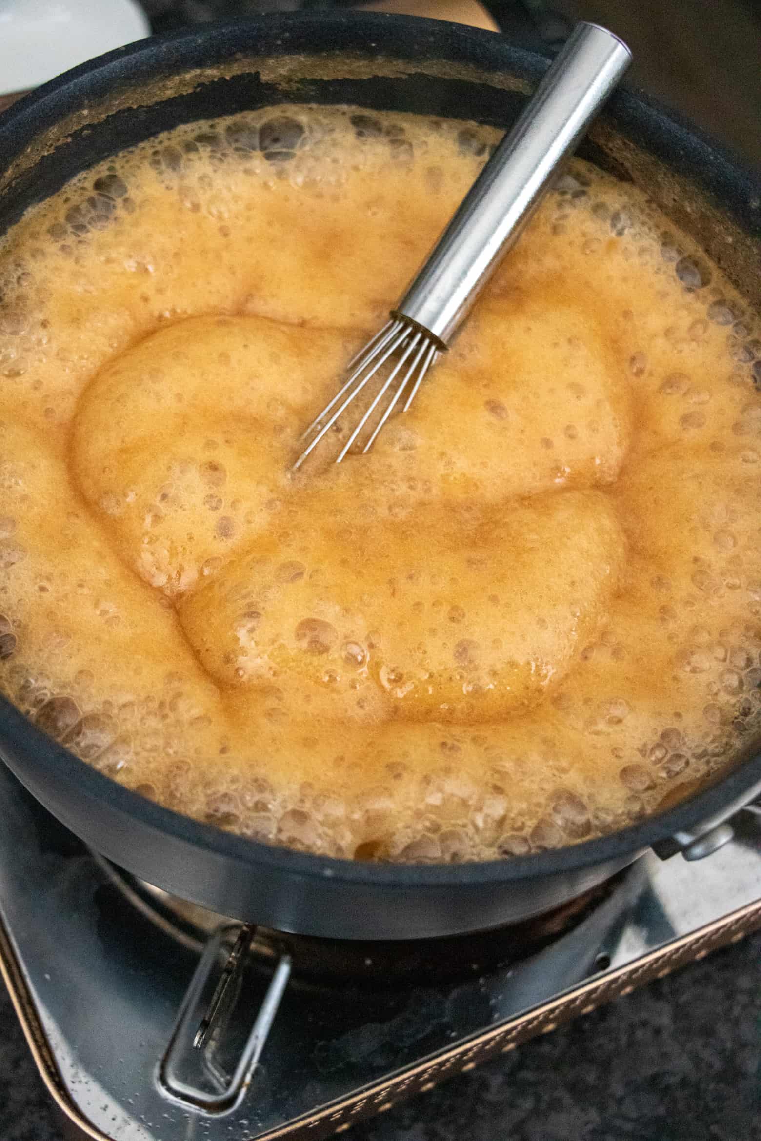 Caramel sauce with milk added to pot..