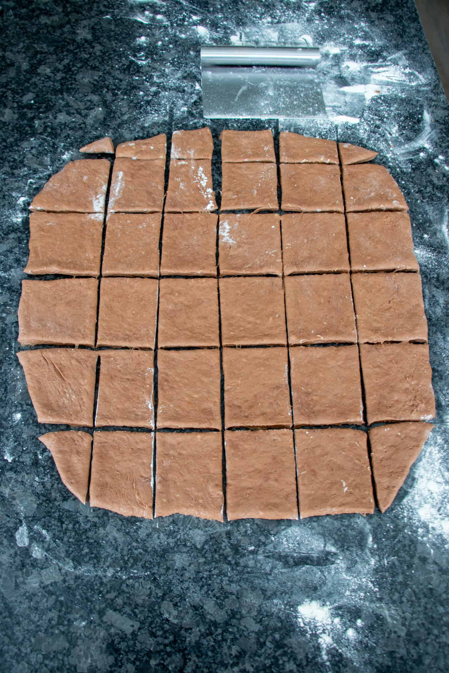 chocolate beignet dough cut into squares.