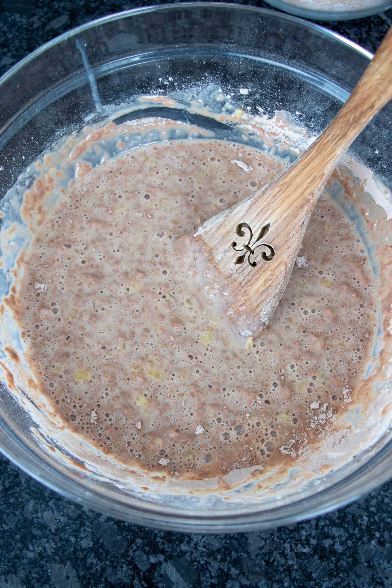 Flour mixture combined with yeast mixture in a bowl.