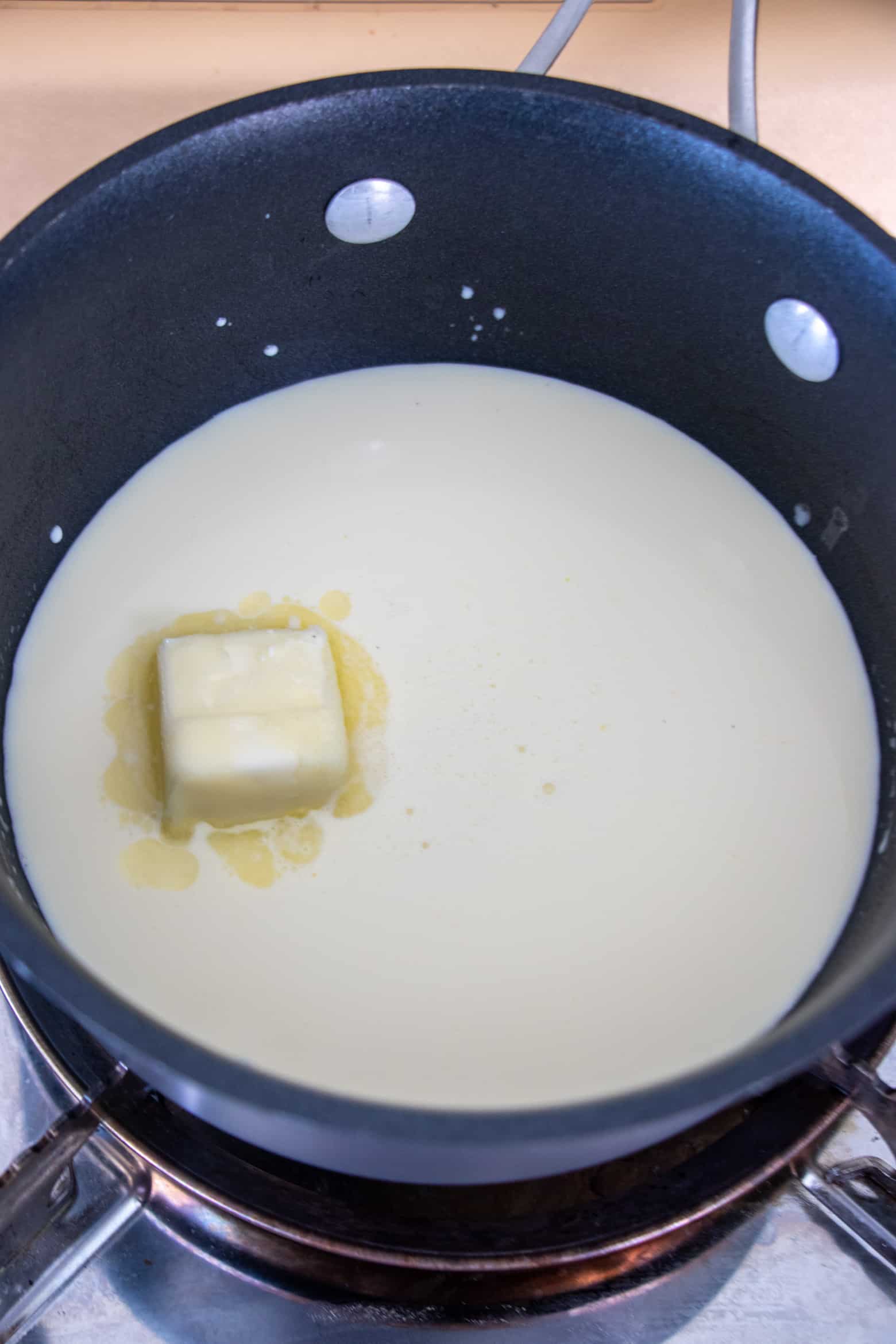 Heavy cream, butter, and sugar in a pot.
