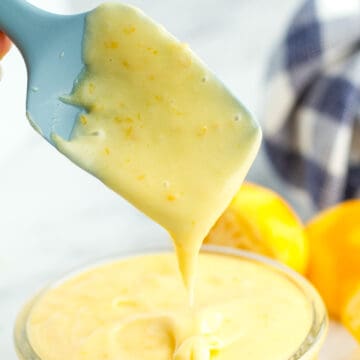 Meyer Lemon Curd being poured from a rubber spatula.