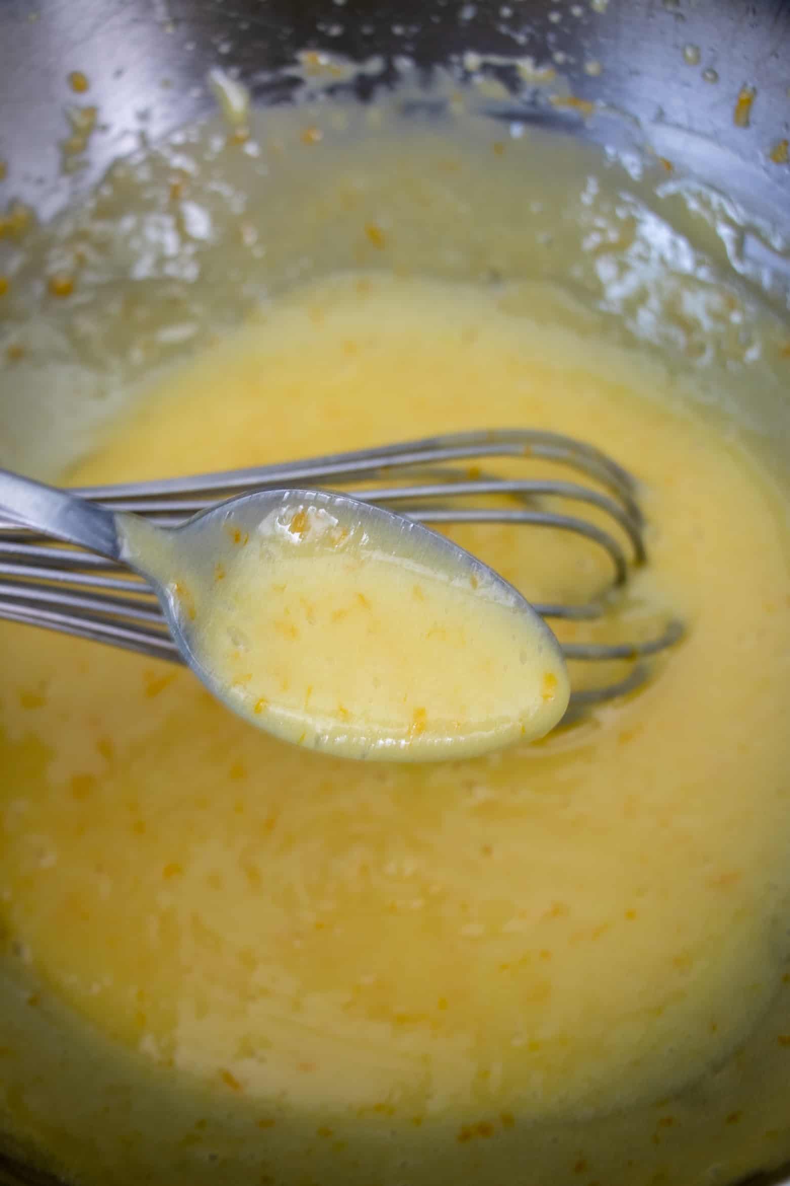 fully cooked meyer lemon curd in a spoon.