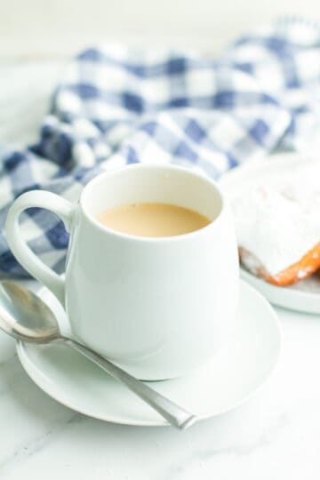 New Orleans Cafe Au Lait in a mug on a saucer.