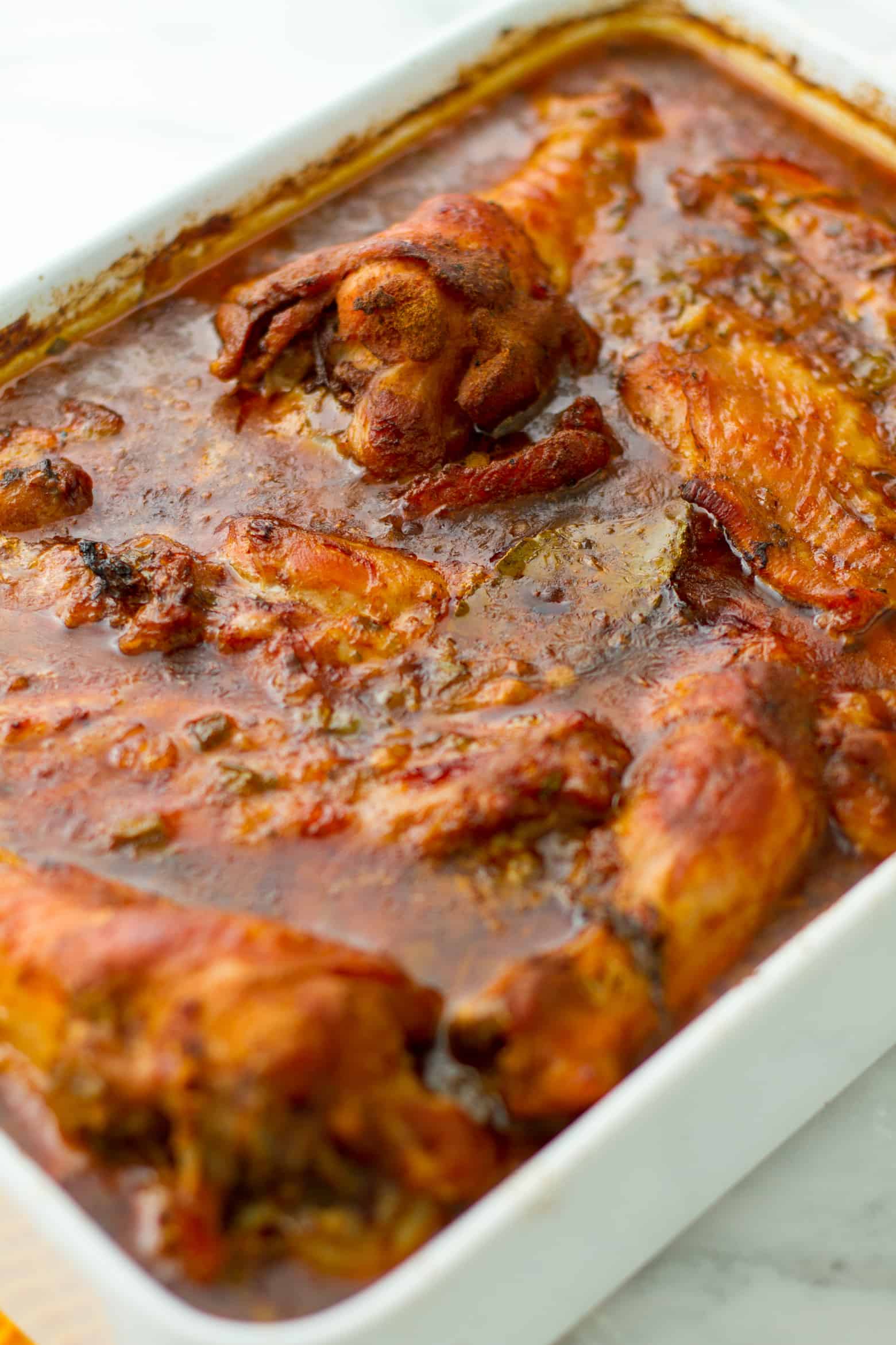 Cooked Southern Smothered Turkey Wings and Gravy in a baking pan.