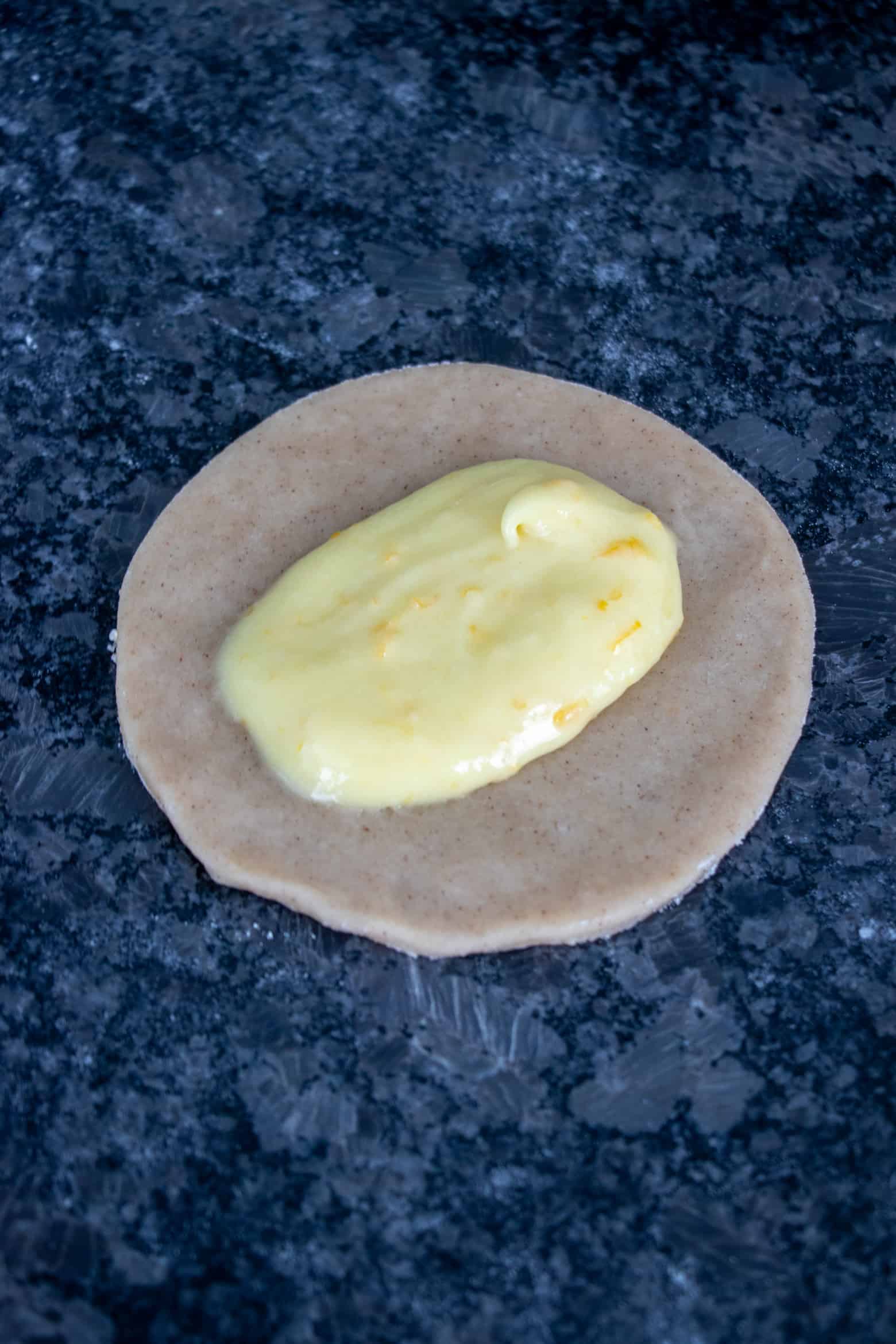 Lemon curd in the center of pie circle.