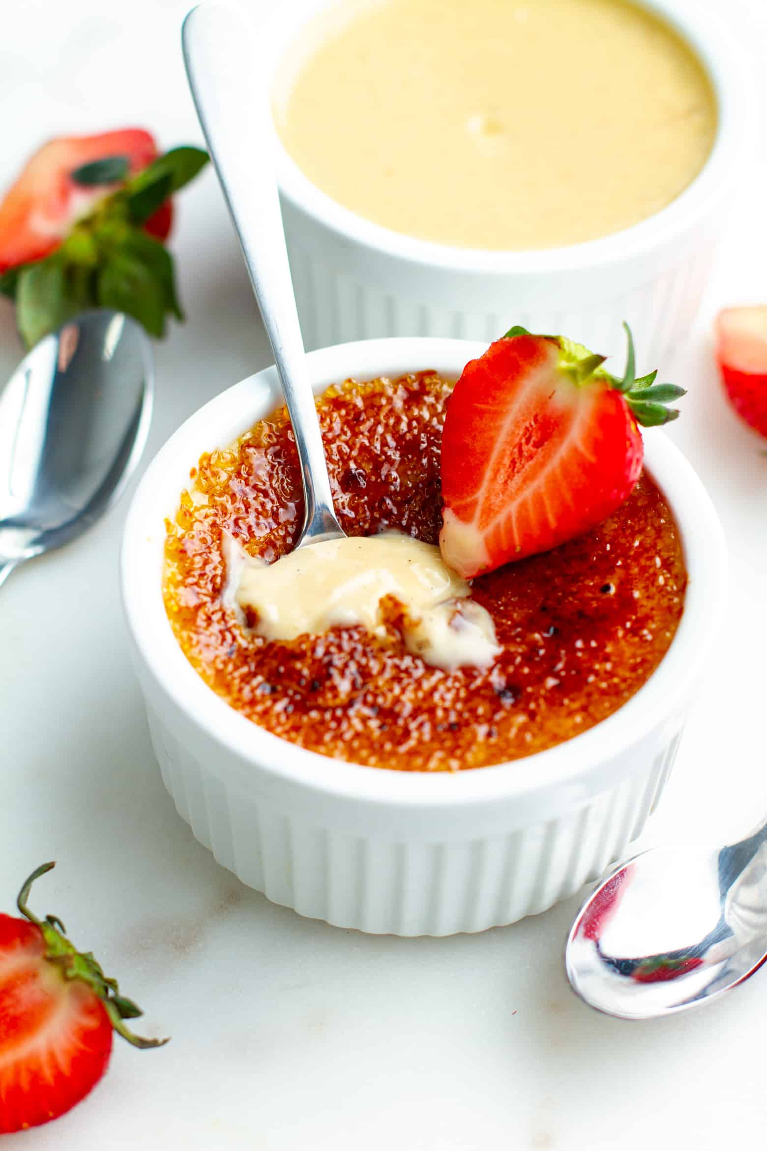 Strawberry Creme Brulee with a spoon inserted.