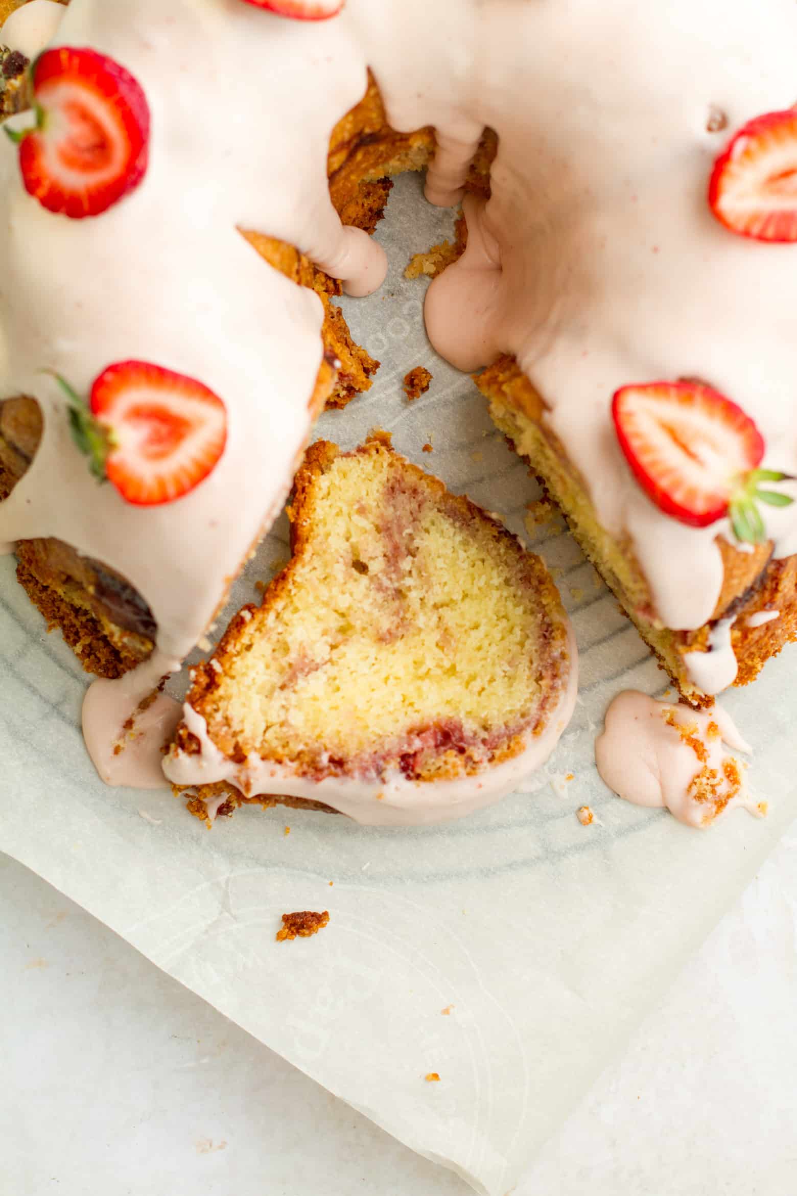 Strawberry pound cake with a slice laying next to it.