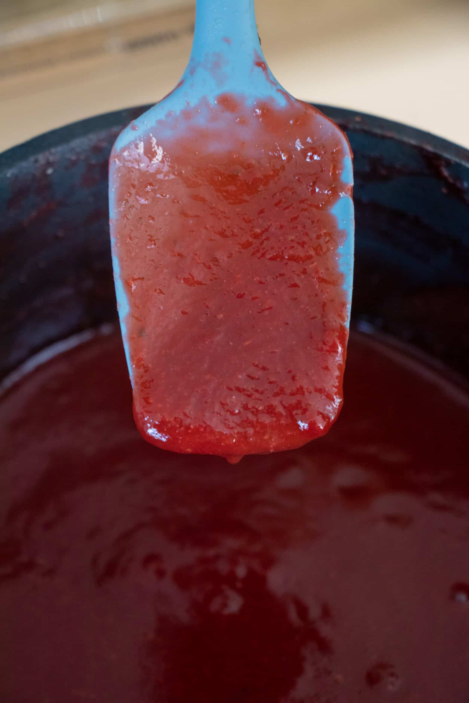 Smooth strawberry sauce on a spatula.