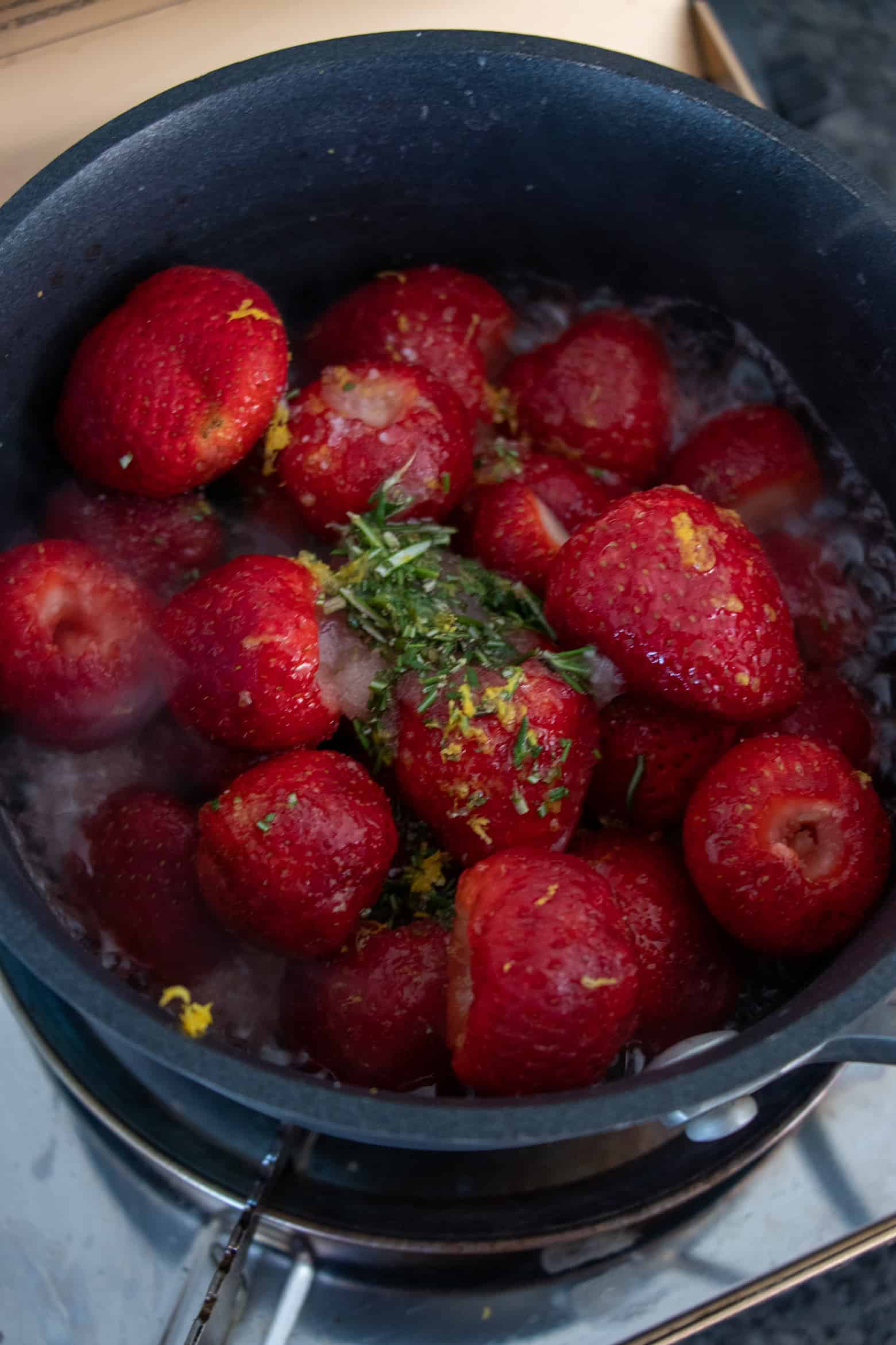 strawberries and sauce ingredients in a pot.