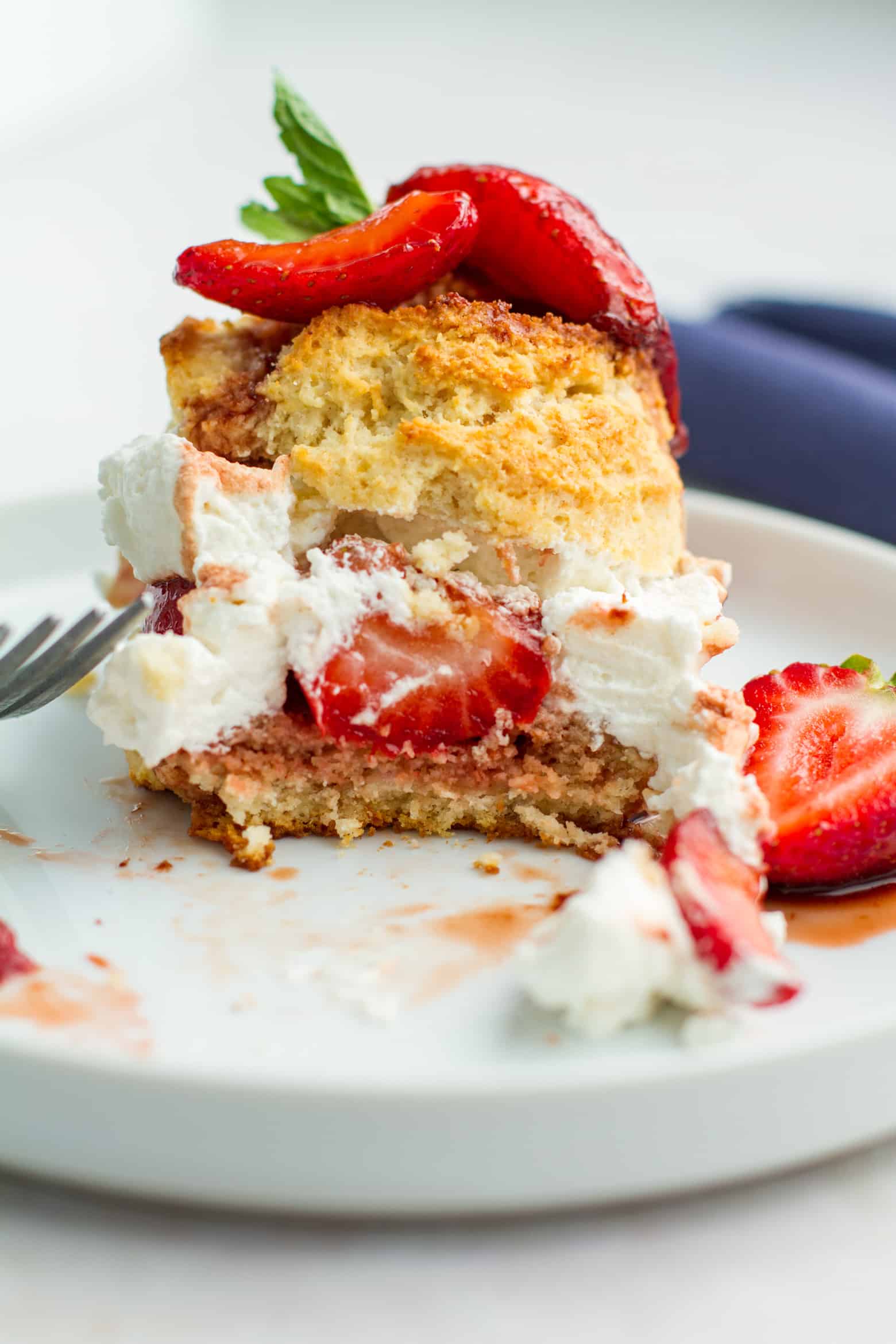 Strawberry Shortcake on a plate with a bite missing.