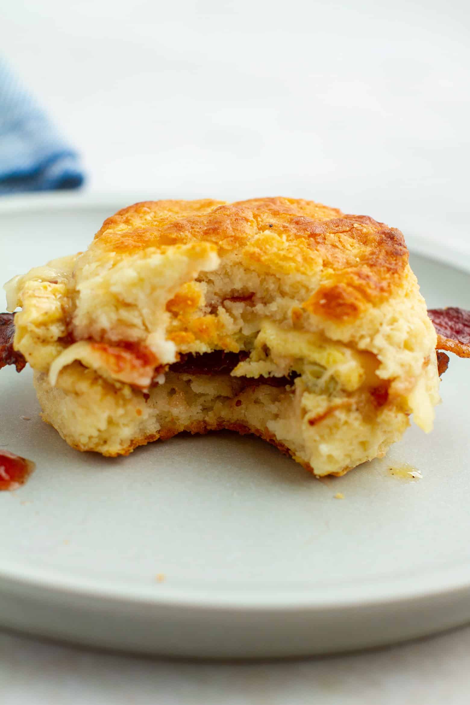 bacon egg and cheese biscuit with a bite taken out.