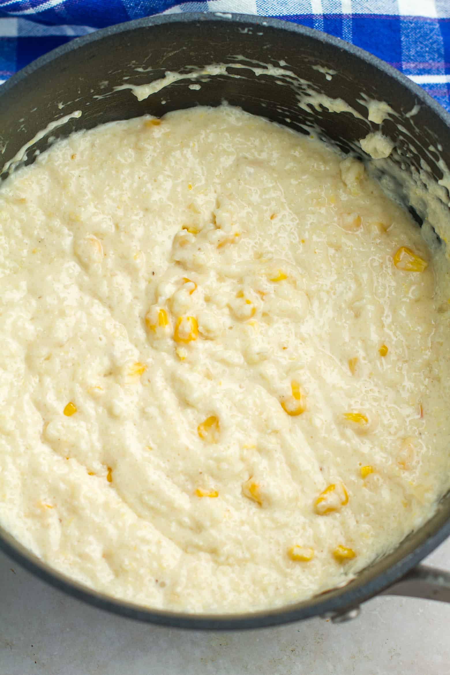 Cooked smoked gouda cheese grits in a pot.