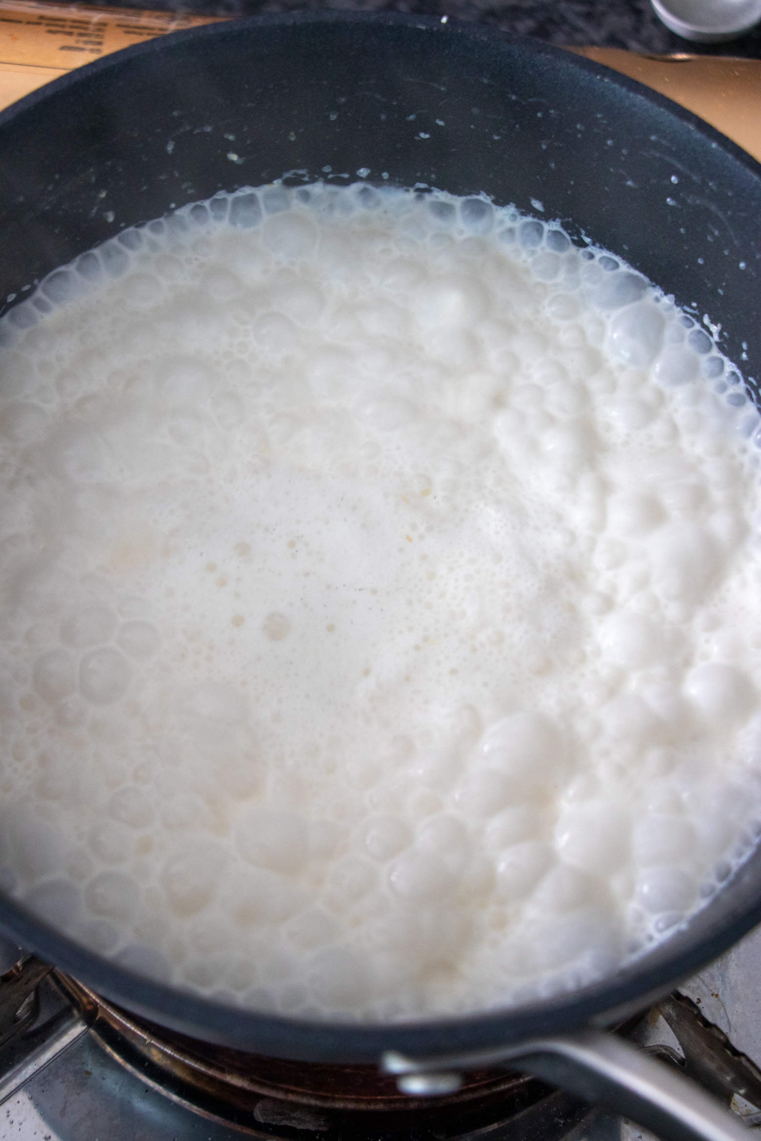 Heavy cream, butter, and water in a pot boiling.