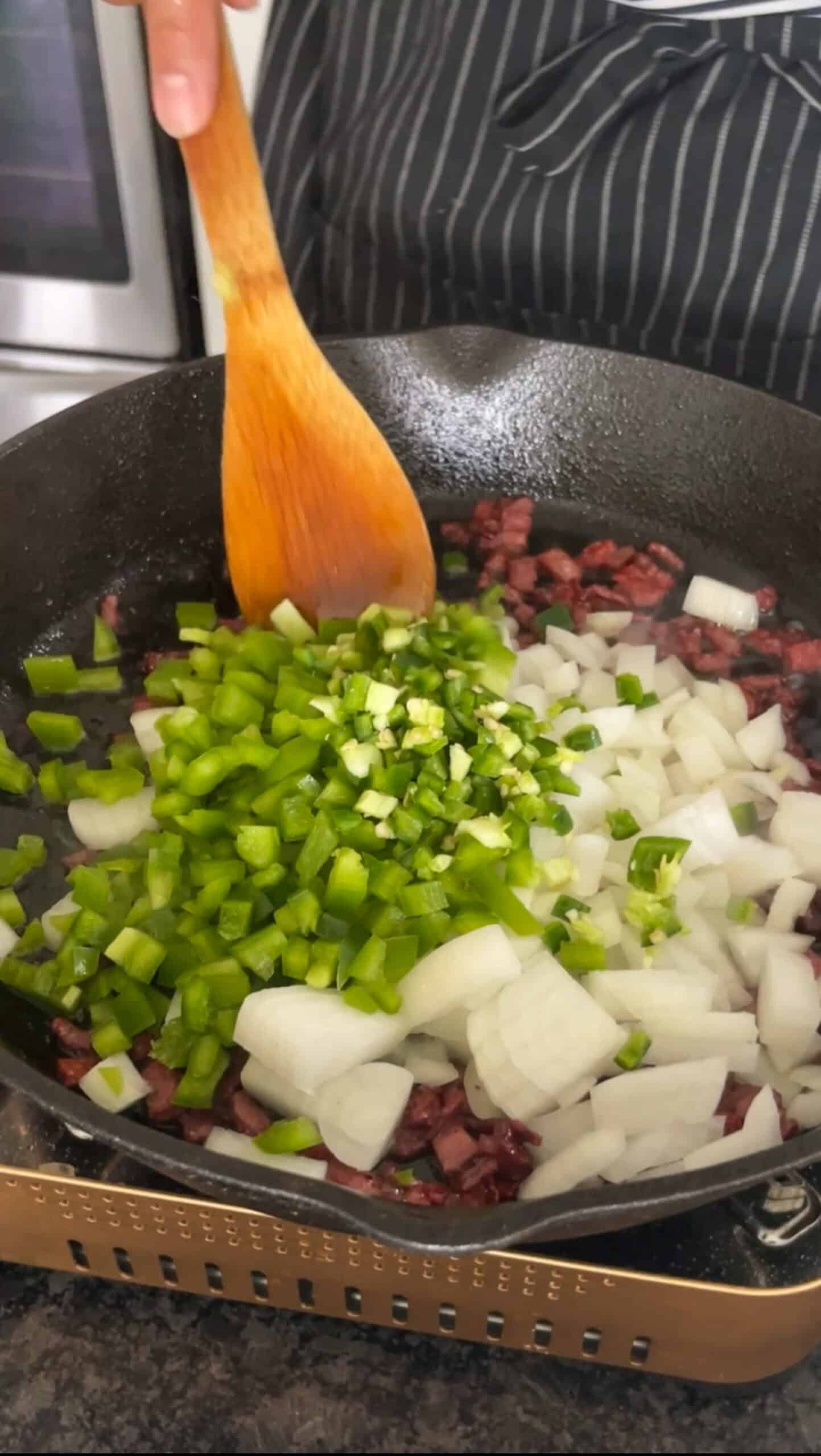 vegetables cooking in the skillet with bacon.