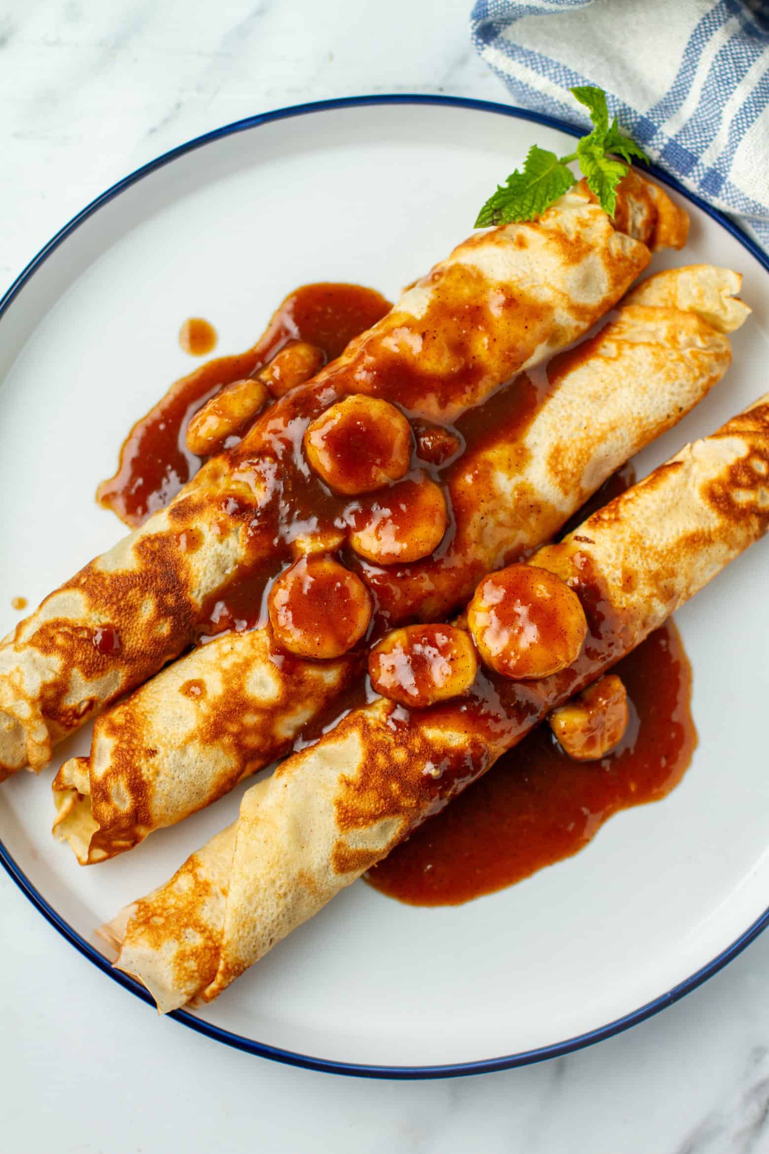 Banana Foster Crepes on a plate.