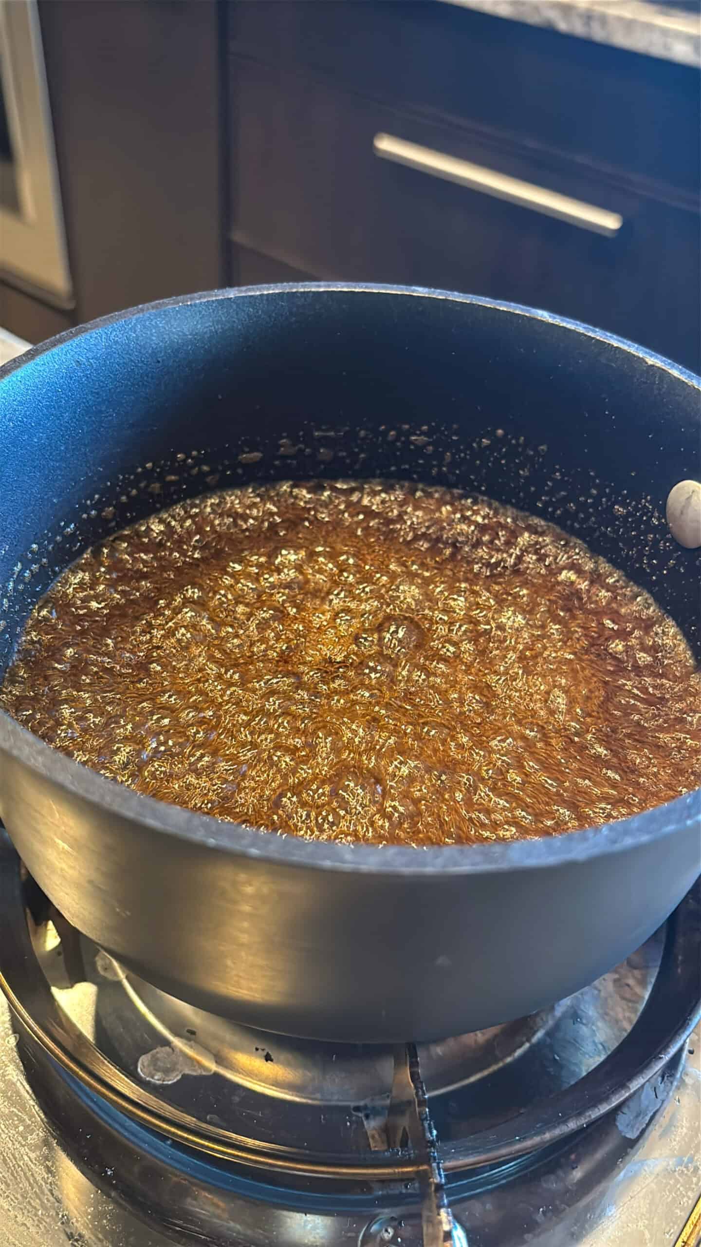 Rum and brown sugar boiling in a pot.
