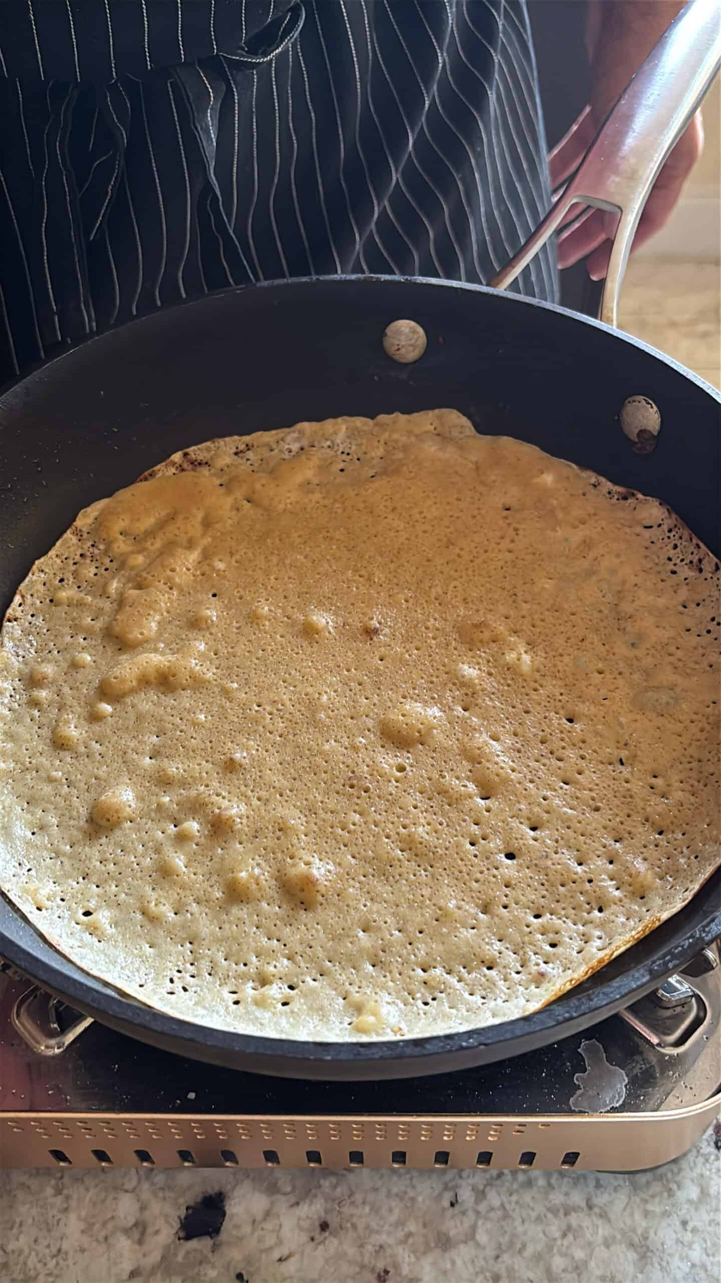 brown butter crepes cooking in a skillet.