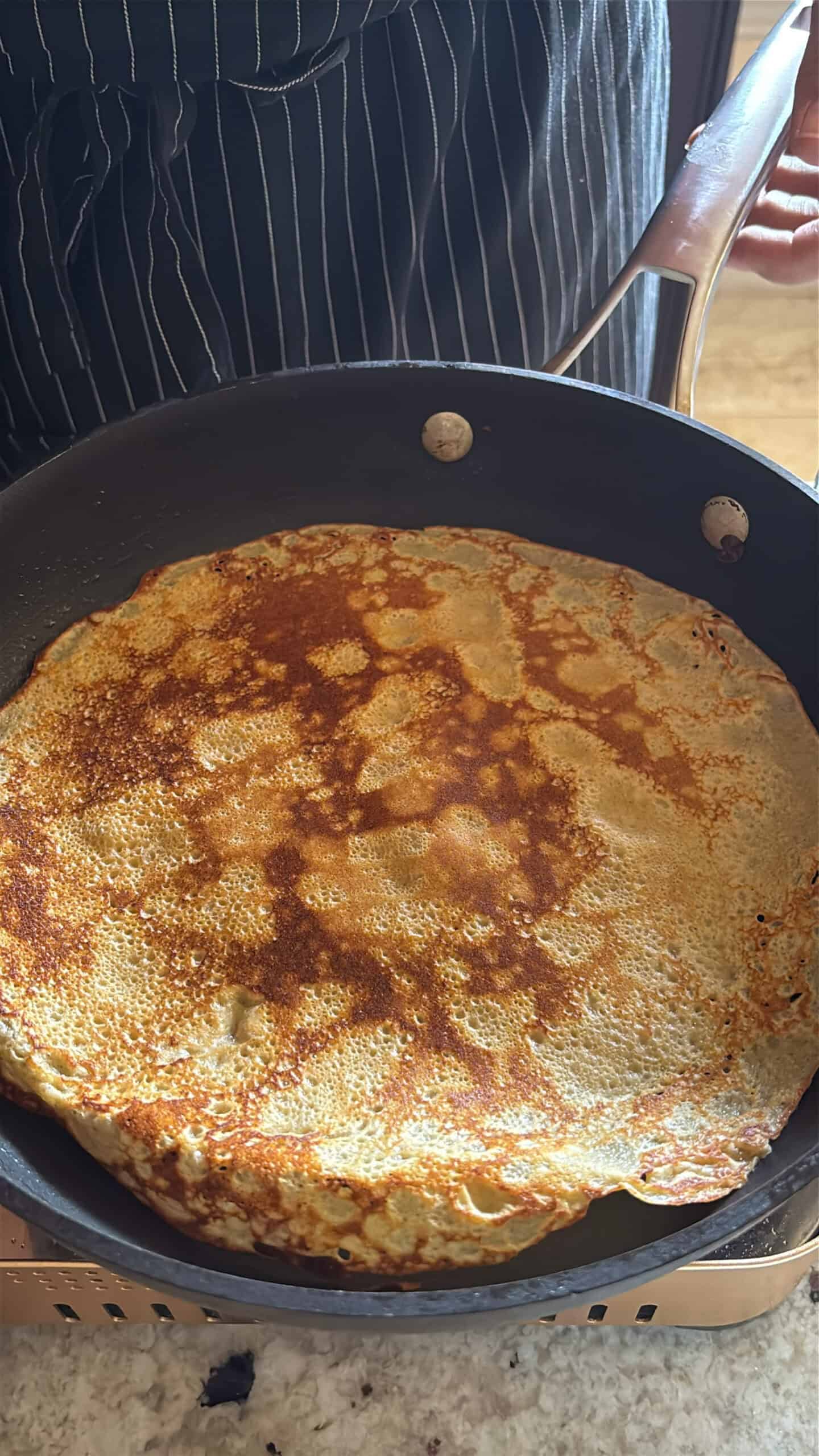 Brown butter crepe cooking on the second side.