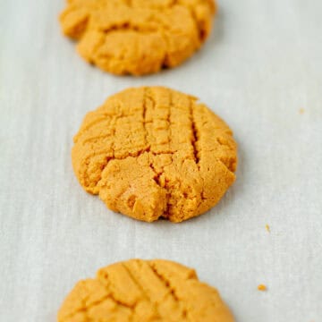 Baked peanut butter cookies on a baking sheet.